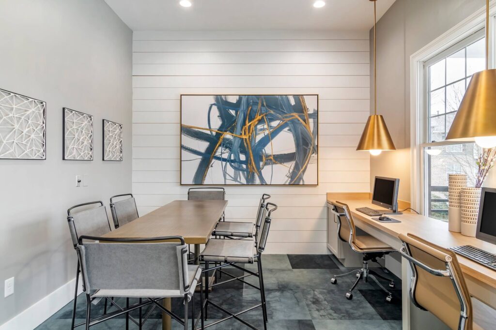 Business center with meeting table and computer stations