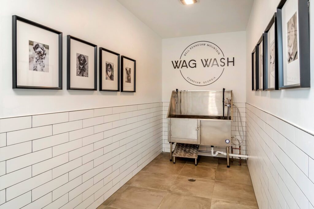 Pet wash station with tub and hose and sign that says wag wash