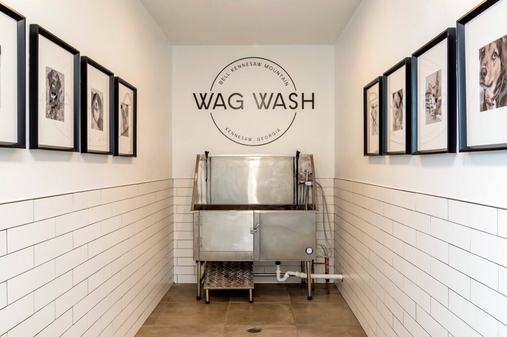 Pet was station with tub and hose and a sign that says wag wash