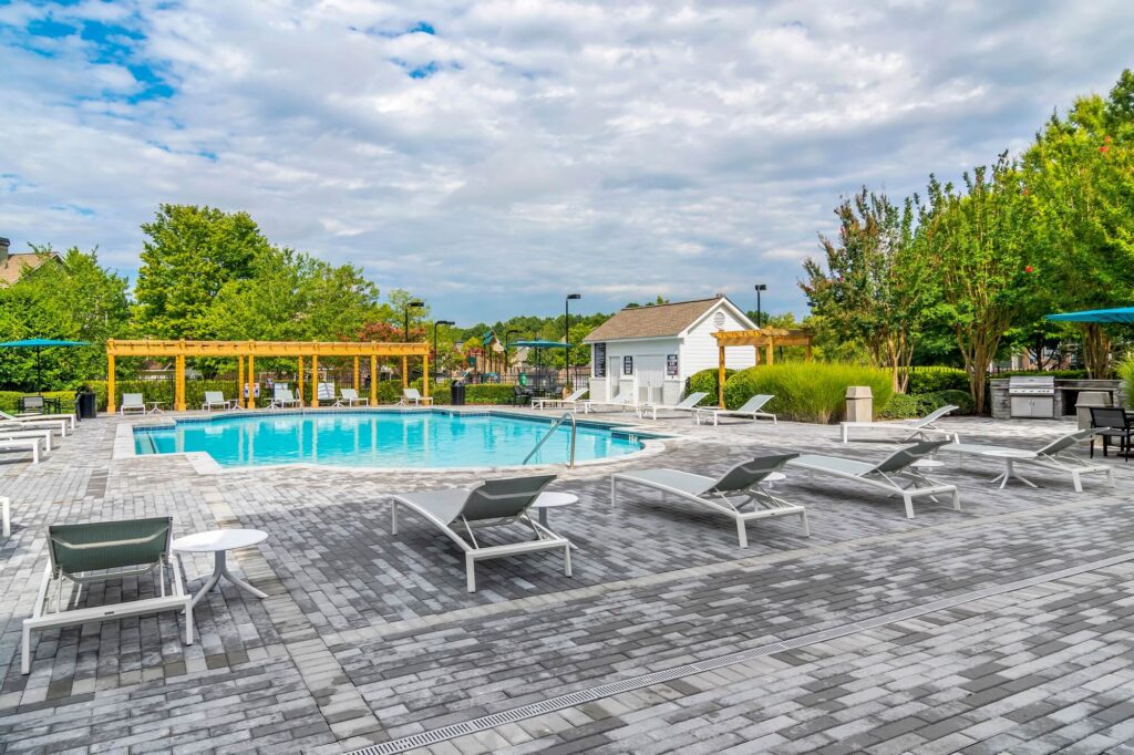 Pool with deck seating and outdoor grill area
