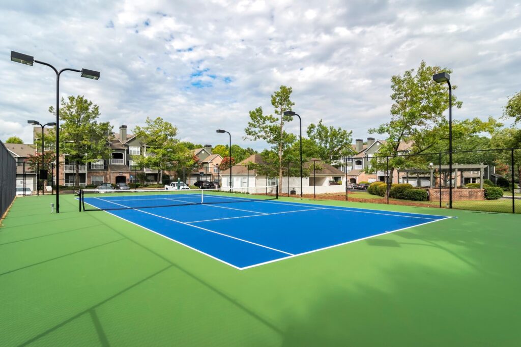 Tennis court surrounded by trees