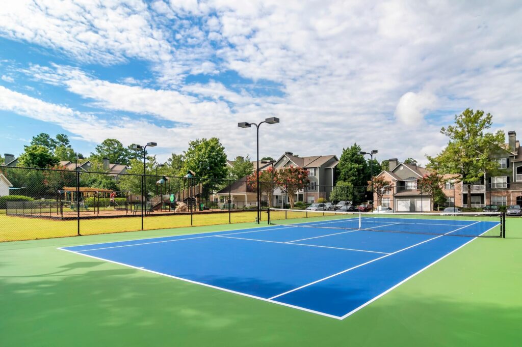 Tennis court next to the playground