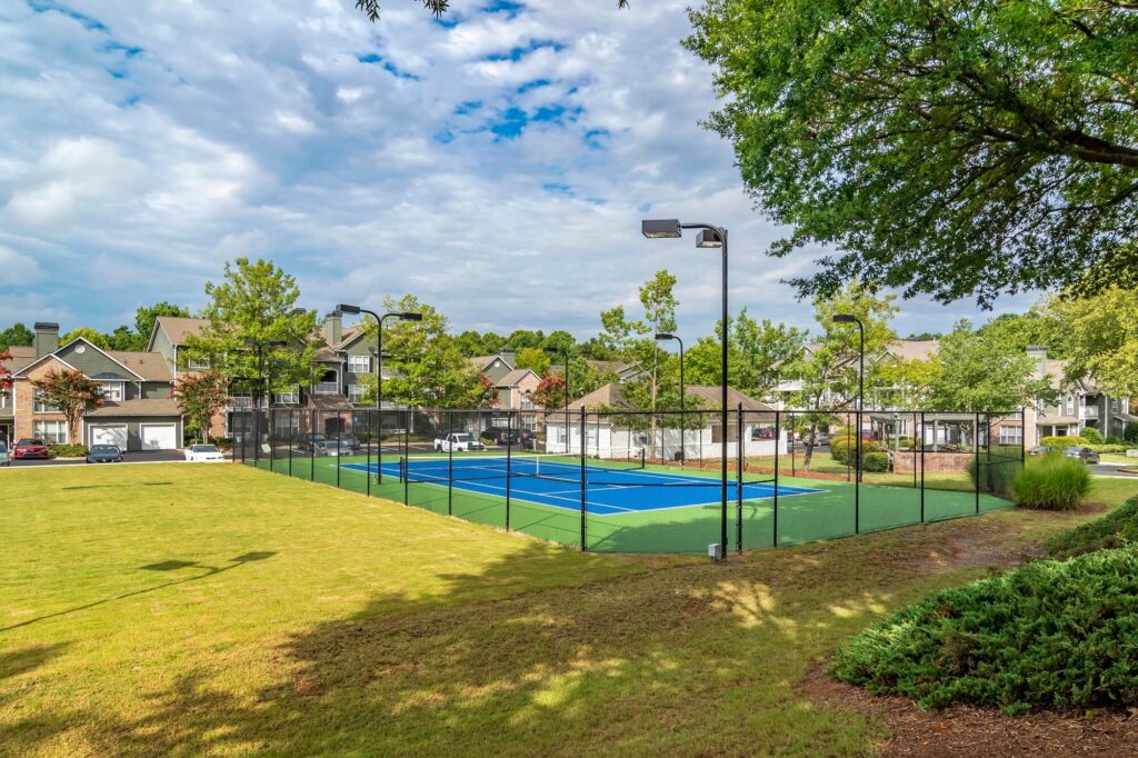 Tennis court surrounded by trees